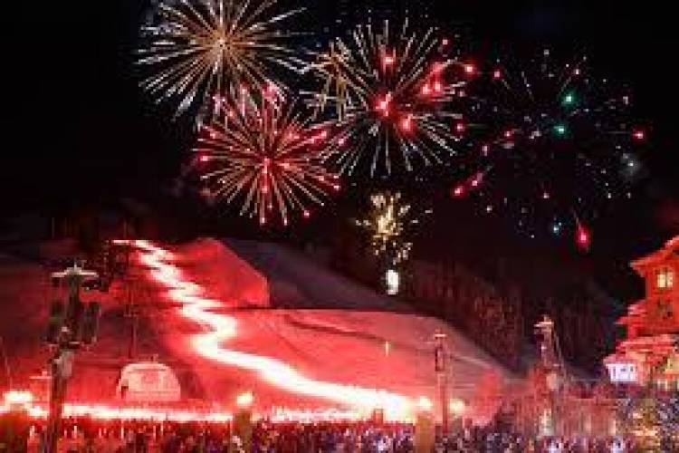 Base of copper mountain filled with people and fireworks lighting up the sky.